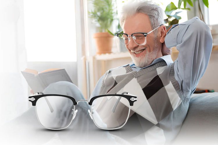 Man relaxing on a sofa with a book, a pair of reading glasses in the foreground